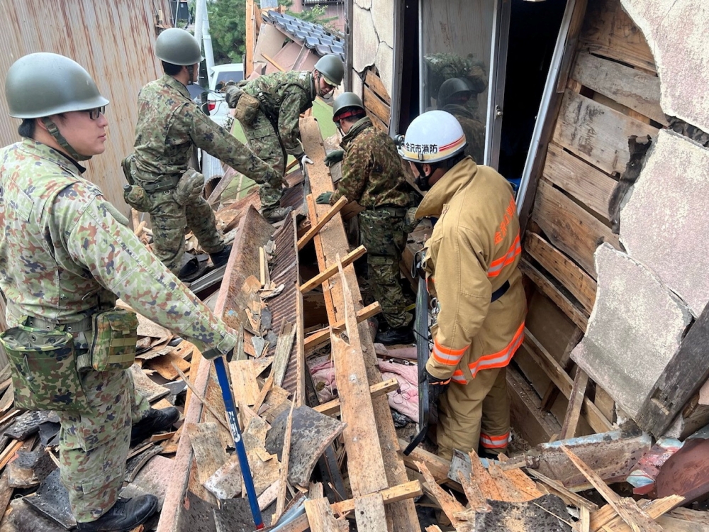 Japanese Self-Defence Force soldiers and firefighters conduct rescue operations at a collapsed house caused by an earthquake in Wajima, Ishikawa prefecture, Japan January 2, 2024, in this handout photo. ― Joint Staff Office of the Defence Ministry of Japan/Handout via Reuters