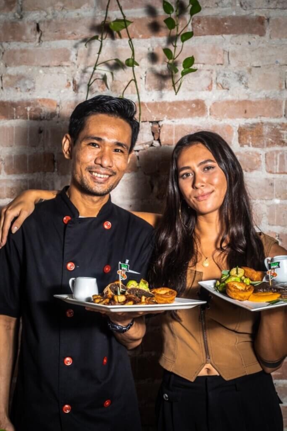 The Hungry Tapir co-founder Makissa Sophia Smeeton (right) and her head chef, Hein Htet Shein, presenting the plant-based ‘Ay-am’ Geprek Burger. — Picture courtesy of Makissa Sophia Smeeton