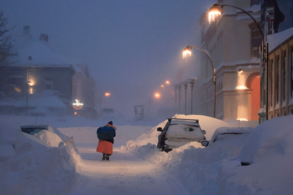A person walks in a snowstorm in Kristiansand, Norway January 3, 2024.  — NTB via Reuters pic