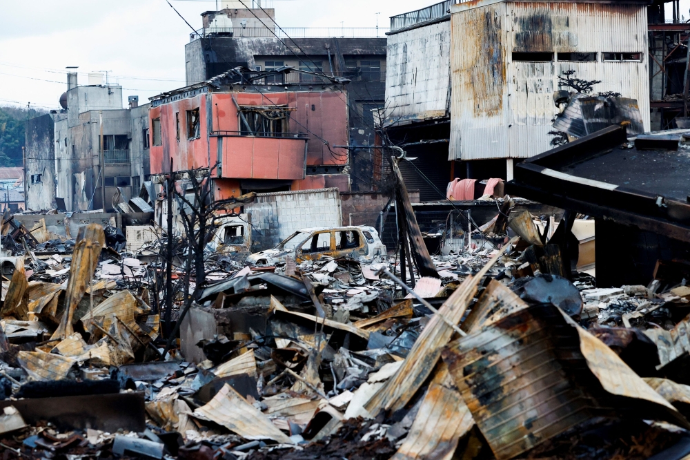 Debris accumulates along Asaichi-dori street, which burned down due to a fire following an earthquake, in Wajima, Japan, January 4, 2024. — Reuters pic