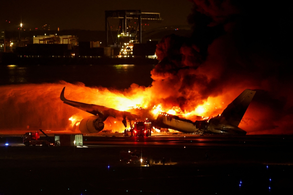 Firefighters work at Haneda International Airport after Japan Airlines’ A350 airplane caught on fire, in Tokyo, Japan January 2, 2024. — Reuters pic 