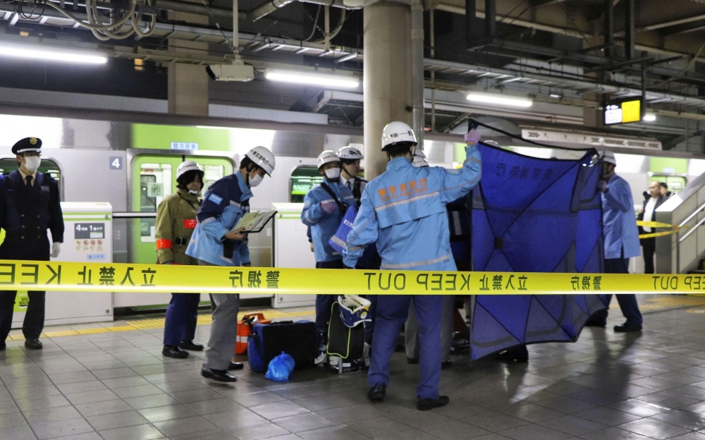 A person who believed to have been stabbed by a knife on the Yamanote loop train line is transported by ambulance members at JR Akihabara Station in Tokyo January 3, 2024, in this photo released by Kyodo. — Kyodo via Reuters pic
