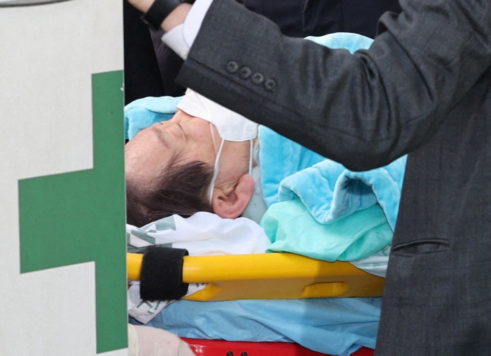 South Korea's opposition Democratic Party leader Lee Jae-myung arrives on a stretcher at Seoul National University hospital after being stabbed in the neck by an unidentified man during his visit to Busan, in Seoul, South Korea, January 2, 2024. — Reuters pic