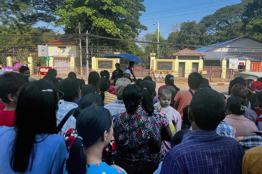 Relatives wait for the release of prisoners outside Insein prison on Myanmar's Independence Day in Yangon on January 4, 2024. — AFP pic