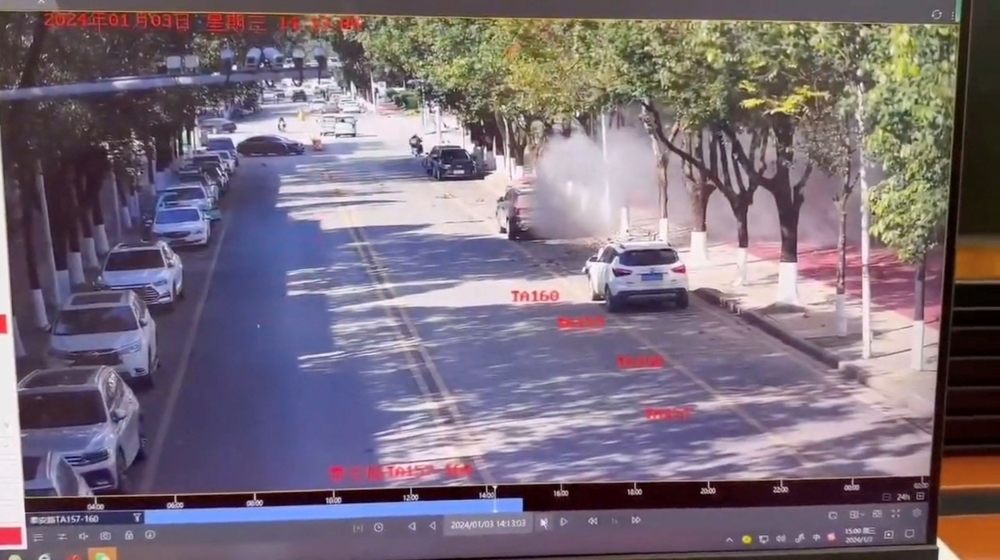 Smoke spreads on a road following an explosion after artillery shells fell in Nansan, Yunnan Province, China, in this screengrab obtained from a video of surveillance footage, released on January 3, 2024. — Video obtained by Reuters