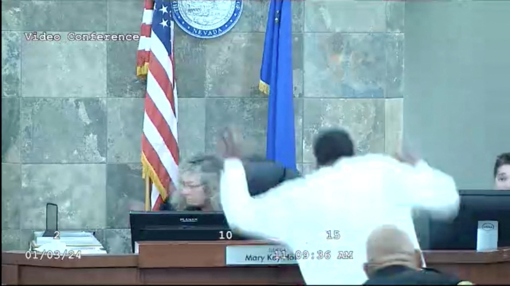 Deobra Redden, who is attending his sentencing hearing for a charge of attempted battery with substantial bodily harm, lunges at Judge Mary Kay Holthus as she hands down the sentence at a court in Las Vegas, Nevada January 3, 2024 in this still image taken from video. — Clark County District Court handout via Reuters