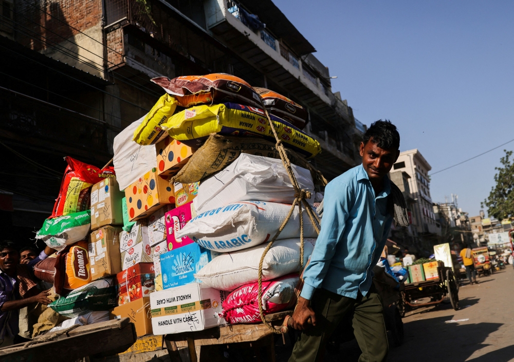A man transports a cart full of sacks at a wholesale market in the old quarters of Delhi, India, June 7, 2023. ― Reuters file pic