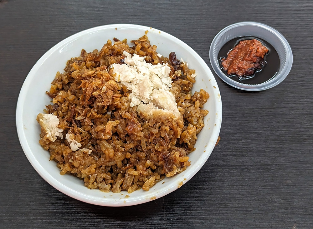Yam Rice comes topped with fried dried shrimp and a dip made of sambal and thick dark soy sauce.