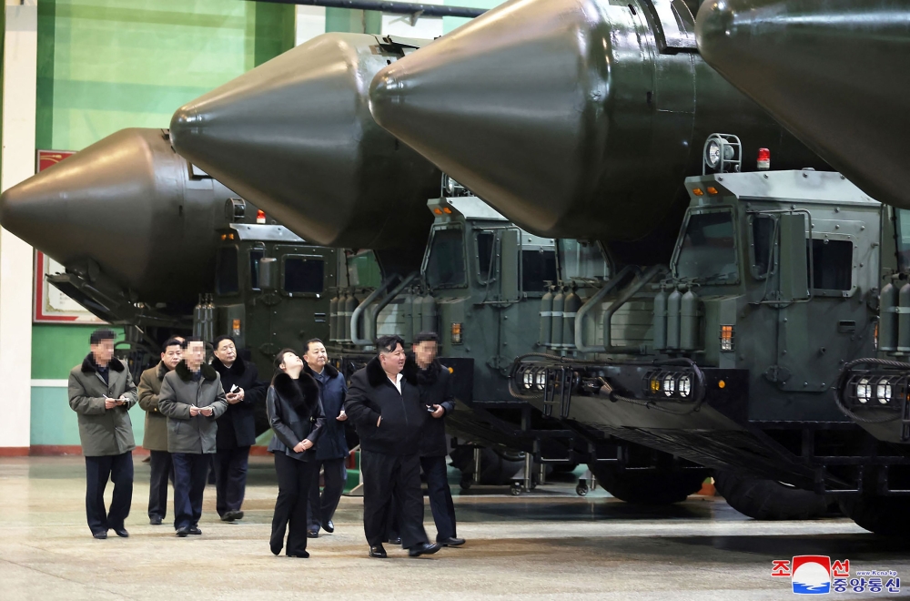  This undated picture released from North Korea's official Korean Central News Agency (KCNA) via KNS on January 5, 2024 shows North Korea's leader Kim Jong-un  inspecting an important military vehicle production plant with his daughter Ju-ae at an undisclosed location in North Korea. — KCNA via KNA / AFP pic