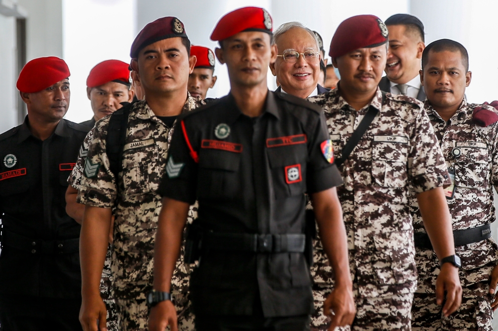 Former prime minister Datuk Seri Najib Razak is escorted by Prison Department personnel at the Kuala Lumpur High Court Complex January 5, 2024. ― Picture by Hari Anggara