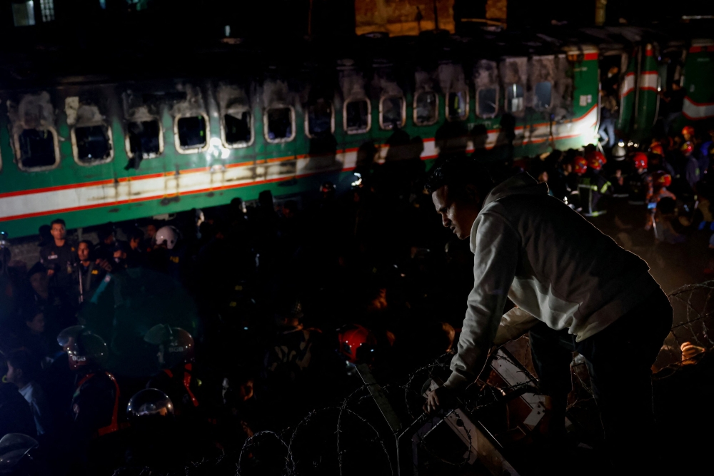 A man looks on at the site where a passenger train caught fire, ahead of the general election, in Dhaka, Bangladesh January 5, 2024. ― Reuters pic