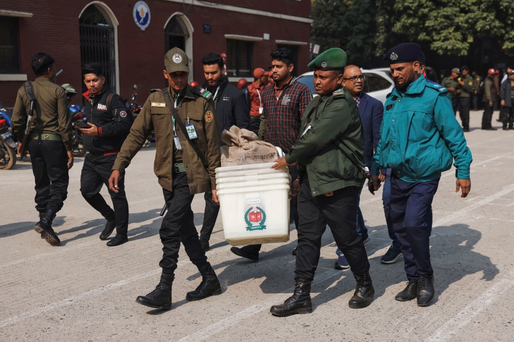 Officials carry ballot boxes for distribution to the voting centres as part of election preparation, a day ahead of the general election in Dhaka, Bangladesh, January 6, 2024. ― Reuters pic