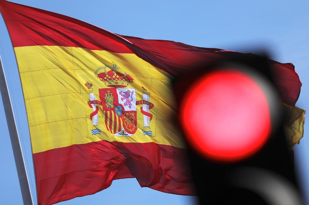 File photo of the Spanish flag fluttering behind a red traffic light at Plaza Colon square in Madrid, Spain, January 10, 2019. - Reuters pic