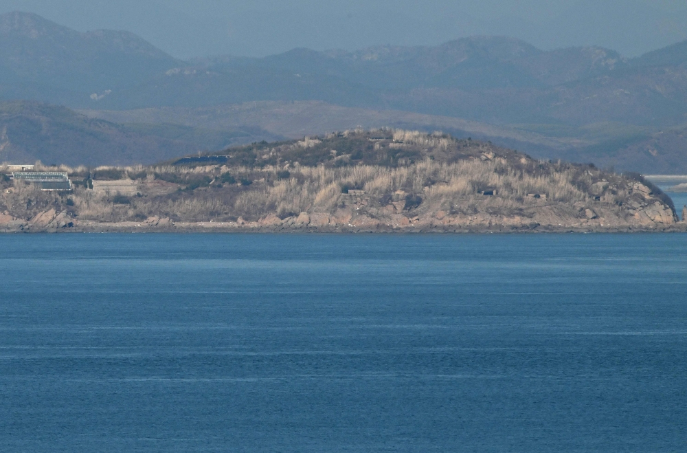 A general view shows the North Korean coastline with artillery bunkers as seen from a viewpoint on Yeonpyeong island, near the ‘northern limit line’ sea boundary with North Korea, on January 6, 2024. ― AFP pic