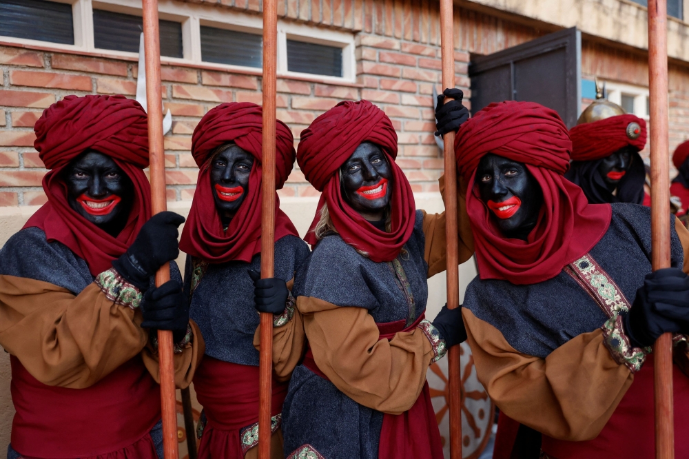 Participants in the Epiphany parade wearing blackface pose for a photo in Alcoy, Spain, January 5, 2024. ― Reuters pic