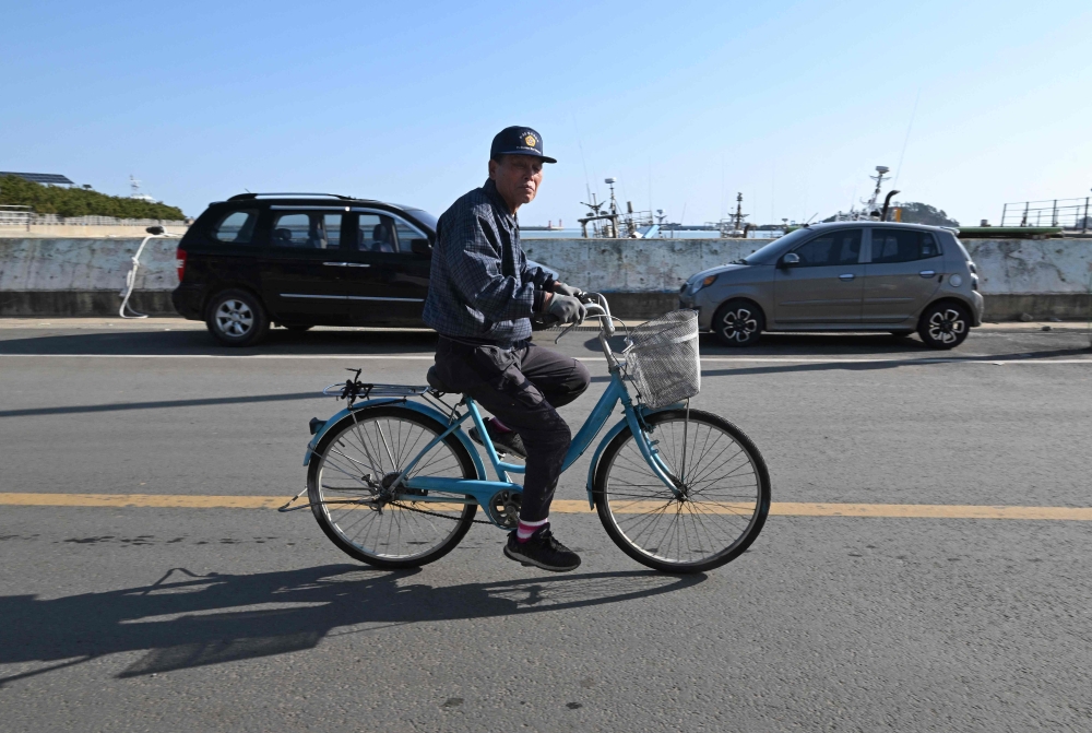 A man rides a bicycle at Yeonpyeong island. — AFP pic
