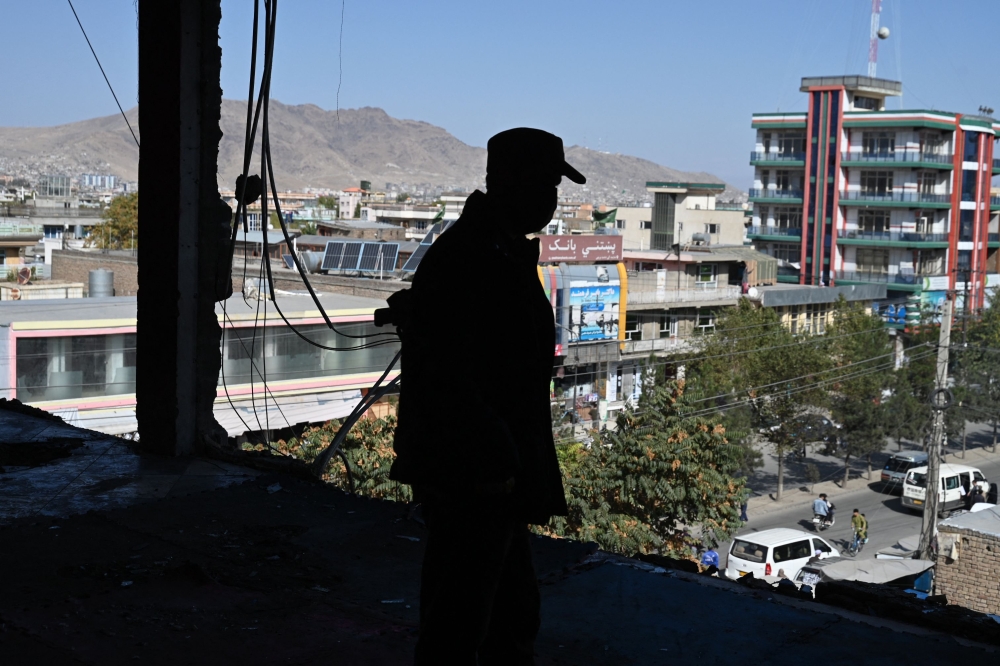 File picture of an Afghan police personnel inspecting the Mellat boxing club, a day after an explosion took place at the site in the Dasht-e-Barchi neighbourhood of Kabul on October 27, 2023. ― AFP pic