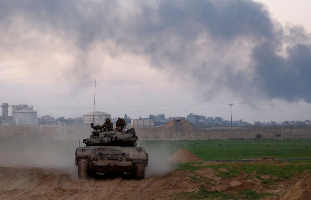 An Israeli tank enters Israel from Gaza, amid the ongoing conflict between Israel and Hamas, at the Israel-Gaza border, Israel, January 6, 2024. — Reuters pic 