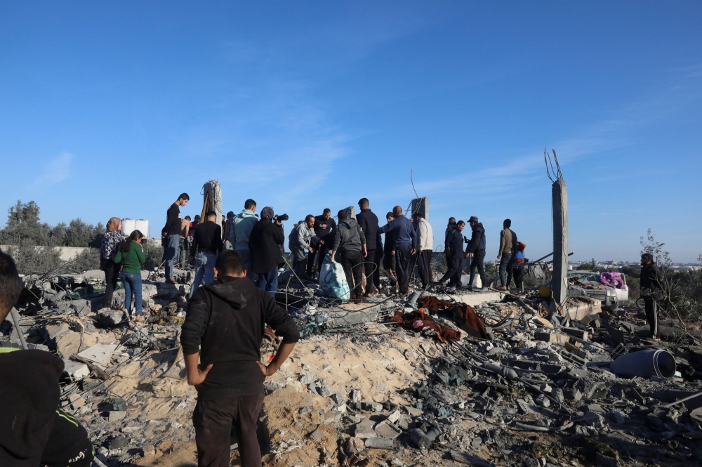 Palestinians inspect the site of an Israeli strike, amid the ongoing conflict between Israel and Palestinian Islamist group Hamas, in Rafah in the southern Gaza Strip, January 7, 2024. — Reuters pic