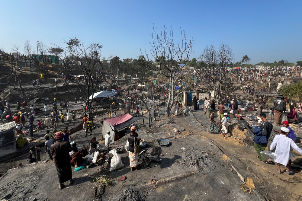 Rohingya refugees work on rebuilding their makeshift shelters after a fire broke out in a camp in Cox’s Bazar January 7, 2024. — Reuters pic