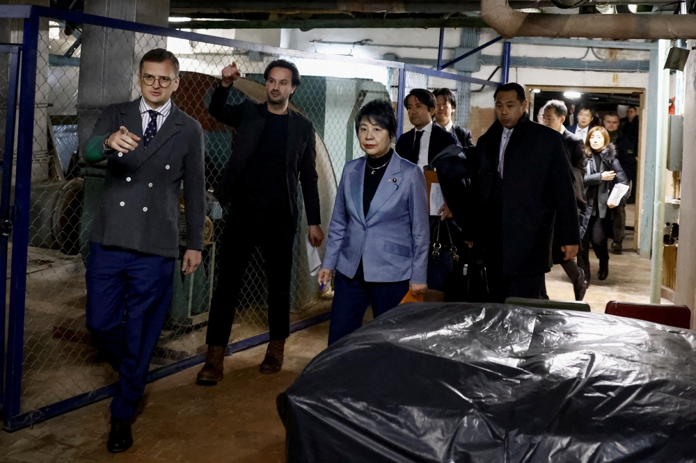 Ukrainian Foreign Minister Dmytro Kuleba and his Japanese counterpart Yoko Kamikawa walk before attending a press conference in a bomb shelter in Kyiv, amid Russia’s attack on Ukraine, January 7, 2024. — Reuters pic