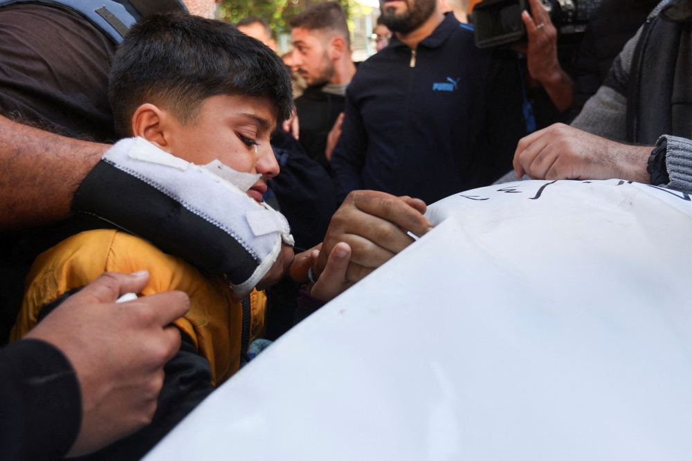 Brother of Palestinian journalist Hamza Al-Dahdouh, the son of Al Jazeera journalist Wael Al-Dahdouh, attends his funeral, after Hamza was killed in an Israeli strike, in Rafah in the southern Gaza Strip, January 7, 2024. — Reuters pic