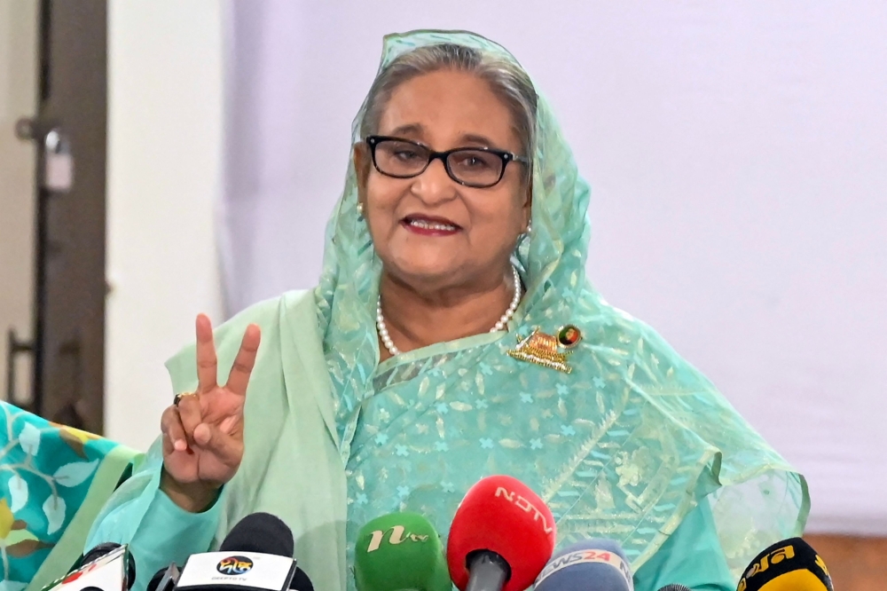 Bangladesh's Prime Minister Sheikh Hasina gestures after casting her vote casts at a polling station in Dhaka on January 7, 2024. — AFP pic