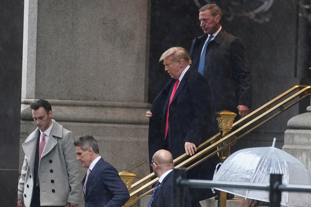 Former US president Donald Trump departs after a brief press conference at a hotel, following his hearing at District Court on Trump's claim of immunity in the federal case accusing him of illegally attempting to overturn his 2020 election defeat, in Washington January 9, 2024. — Reuters pic