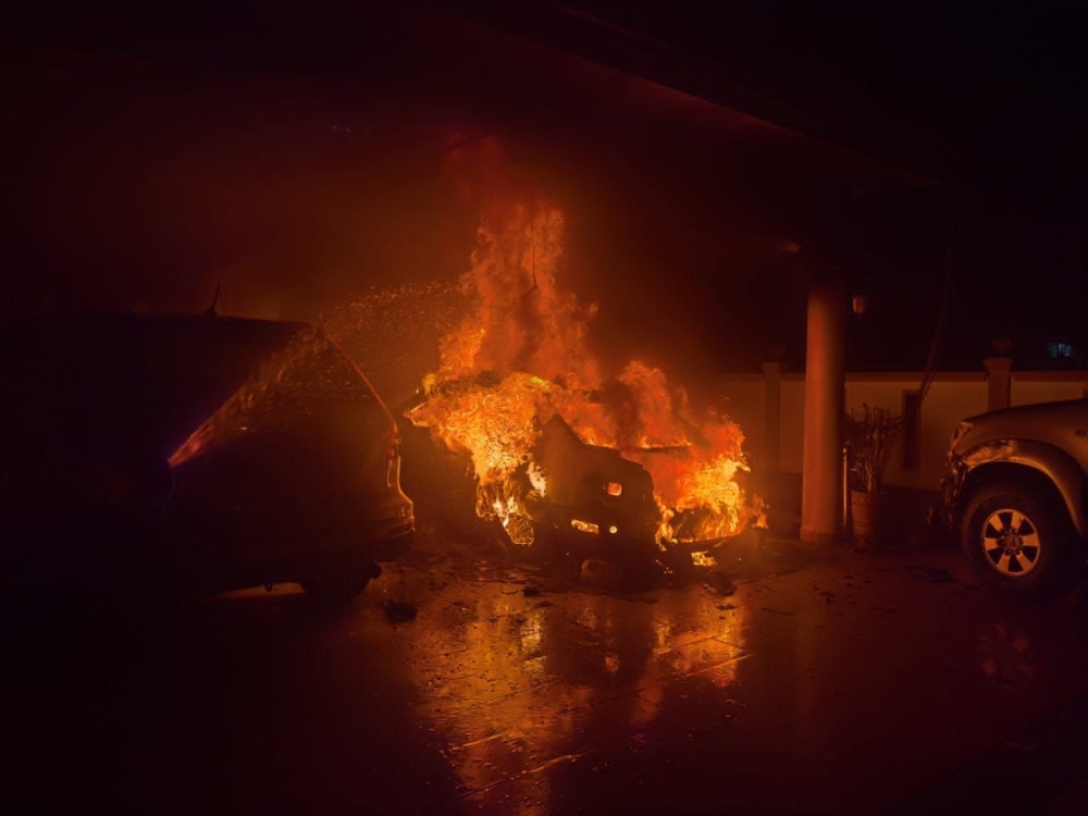 Firemen work to extinguish the blaze at the home of Beruas MP Datuk Ngeh Koo Ham this morning. — Picture courtesy of the Fire and Rescue Department