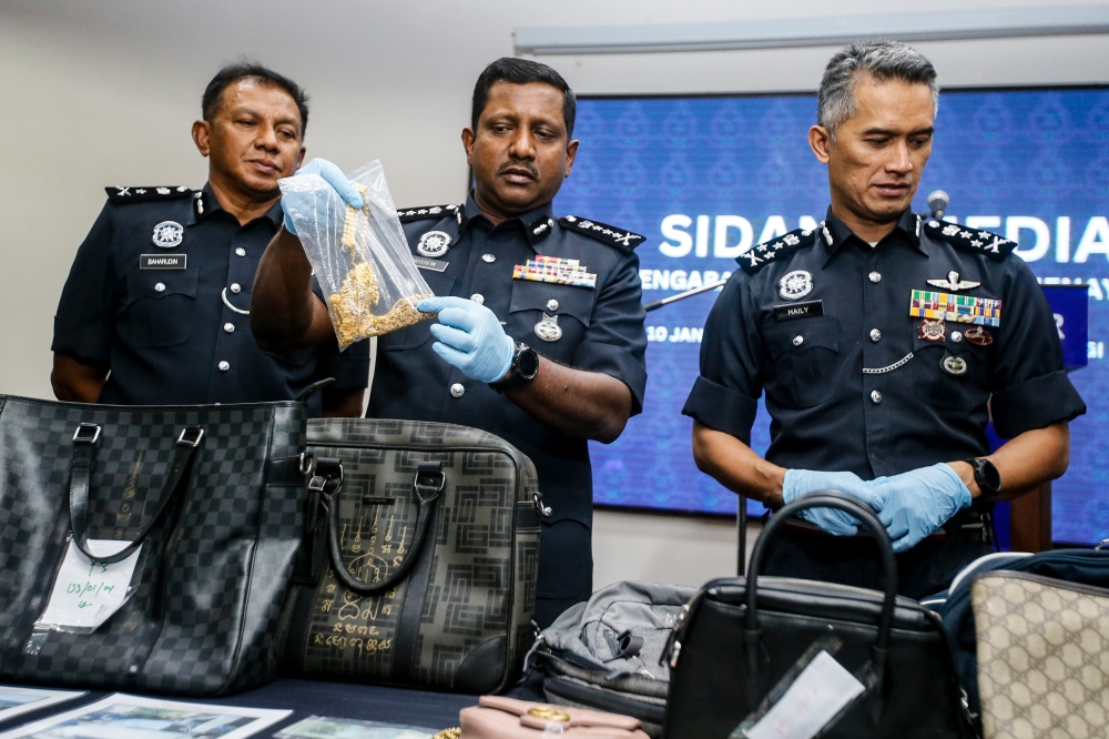 Selangor police chief Datuk Hussein Omar Khan (centre) and Bukit Aman Criminal Investigation Department (JSJ) director Datuk Seri Mohd Shuhaily Mohd Zain (right) during a press conference at the Selangor Police Contingent Headquarters January 10, 2024. — Picture by Hari Anggara