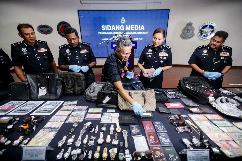 Watches, jewellery and other seized items are on display during a press conference by the police, at the Selangor Police Contingent Headquarters in Shah Alam January 10, 2024. — Picture by Hari Anggara