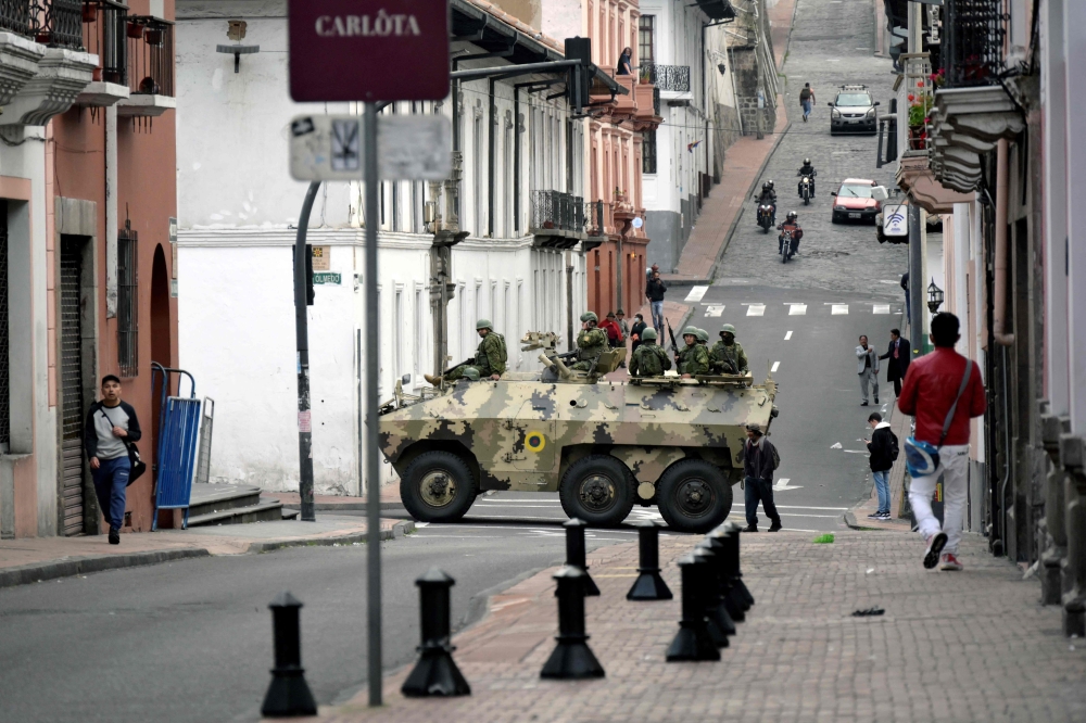 Ecuadorean security forces patrol the area around the main square and presidential palace after Ecuadorean President Daniel Noboa declared the country in a state of ‘internal armed conflict’ and ordered the army to carry out military operations against the country's powerful drug gangs, in downtown Quito on January 9, 2024. — AFP pic 