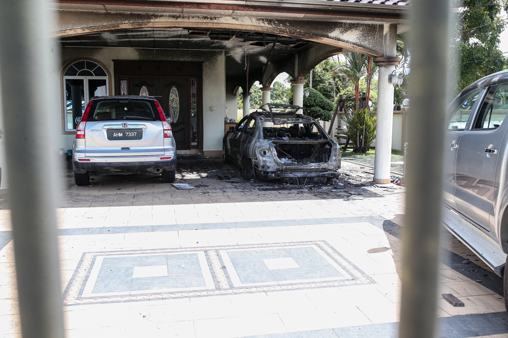 Damaged vehicles at the residence of Beruas MP Ngeh Koo Ham which caught fire early this morning in Ayer Tawar near Manjung, in what was believed to be a Molotov cocktail attack. — Picture by Farhan Najib