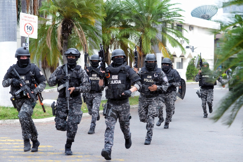 An Ecuadorean police squad enters the premises of Ecuador's TC television channel after unidentified gunmen burst into the state-owned television studio live on air on January 9, 2024, in Guayaquil, Ecuador, a day after Ecuadorean President Daniel Noboa declared a state of emergency following the escape from prison of a dangerous narco boss. — AFP pic 