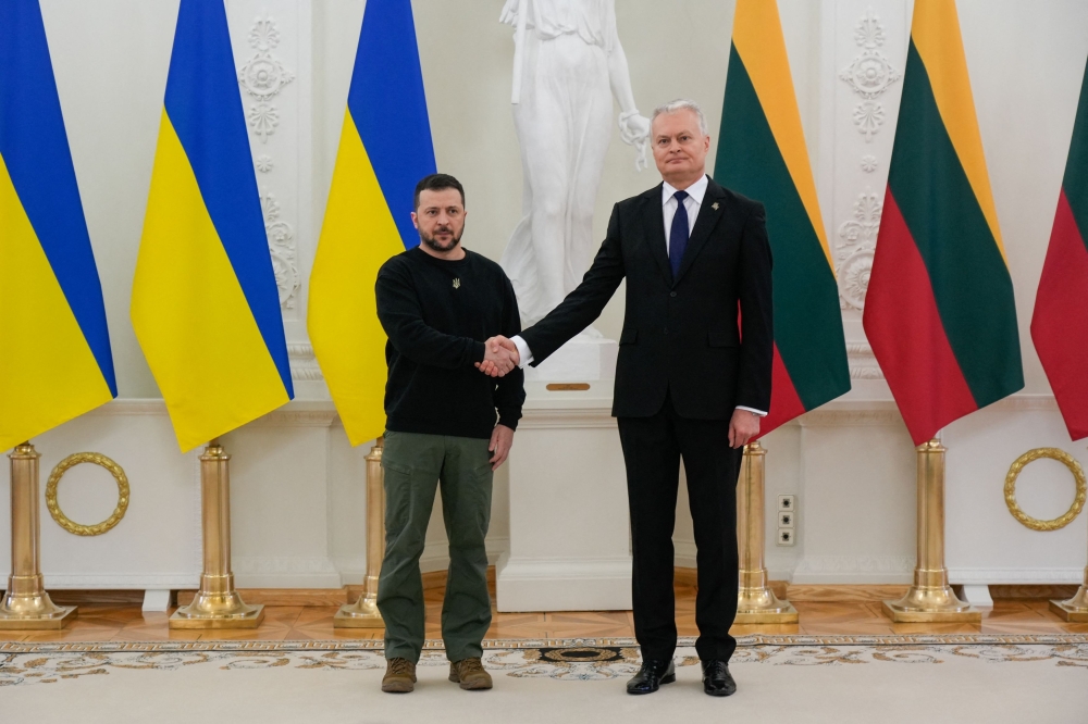Lithuania's President Gitanas Nauseda shakes hands with Ukraine's President Volodymyr Zelenskiy in Vilnius, Lithuania January 10, 2024. — Reuters pic  