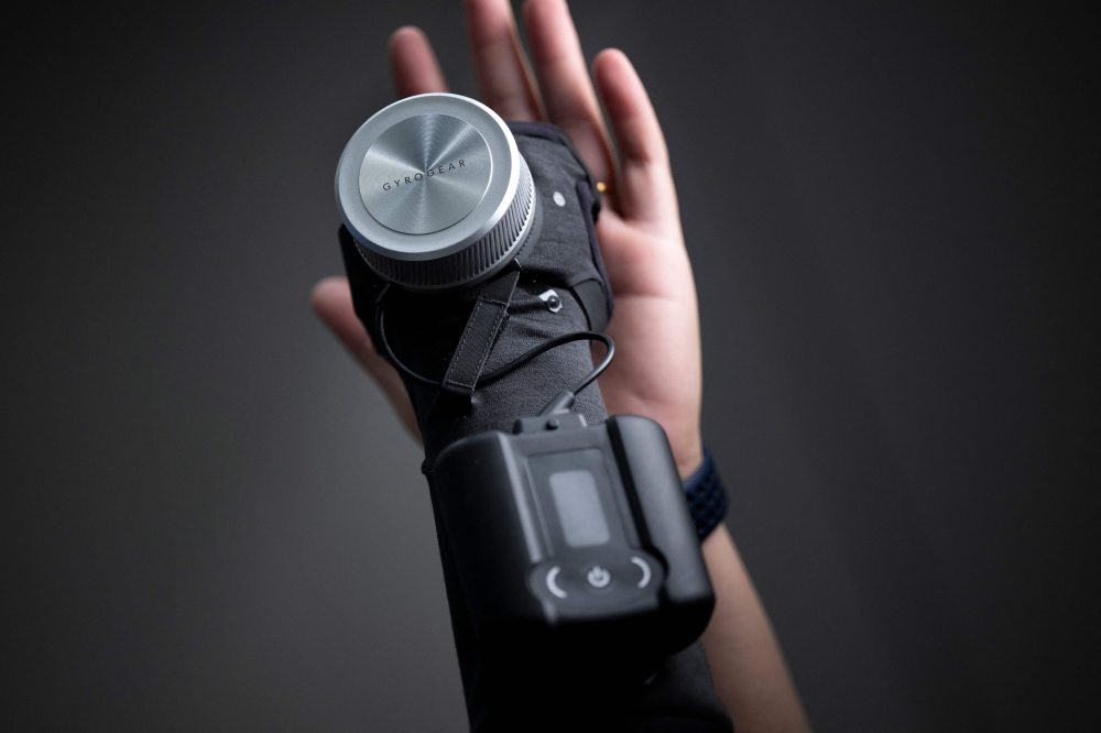 Dr. Faii Ong, founder and CEO of GyroGear, holds up a GyroGlove which uses a gyroscope to help stabilize people's hands who suffer from tremors at the Mandalay Bay resort before this week's Consumer Electronics Show (CES) on January 8, 2024 in Las Vegas, Nevada. — AFP pic