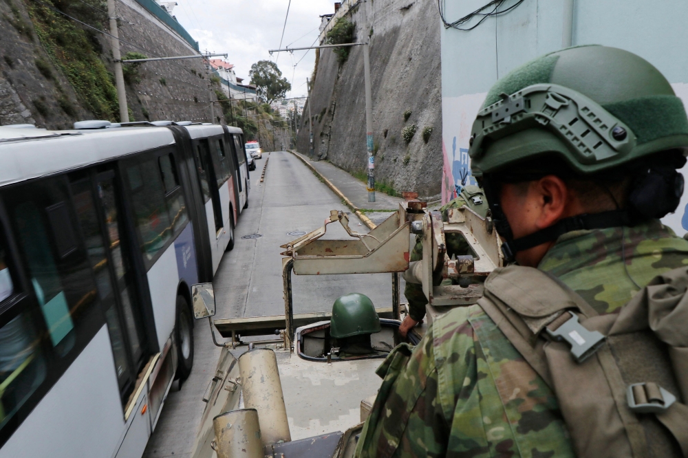 Members of the Armed Forces patrol a street during an operation to protect civil security in Quito, on January 10, 2024. Ecuador's president Daniel Noboa gave orders on Tuesday to 'neutralise' criminal gangs after gunmen stormed and opened fire in a TV studio, as bandits threatened random executions on a second day of terror in the country. — AFP pic