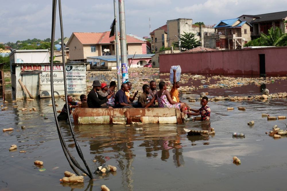 People use a makeshift boat to move after the Congo River rises to its highest level, causing flooding in Kinshasa, Democratic Republic of Congo January 10, 2024. — Reuters pic