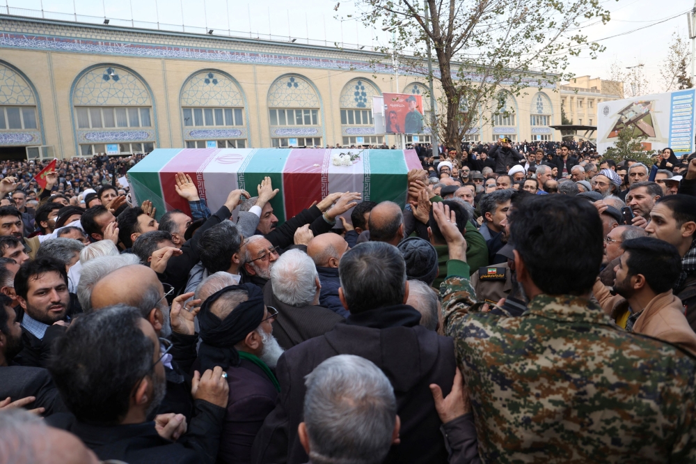People carry the coffin of Faezeh Rahimi, one of the casualties of the Islamic State attack in Kerman, after Friday prayers in Tehran, Iran, January 5, 2024. — Majid Asgaripour/Wana (West Asia News Agency) pic via Reuters