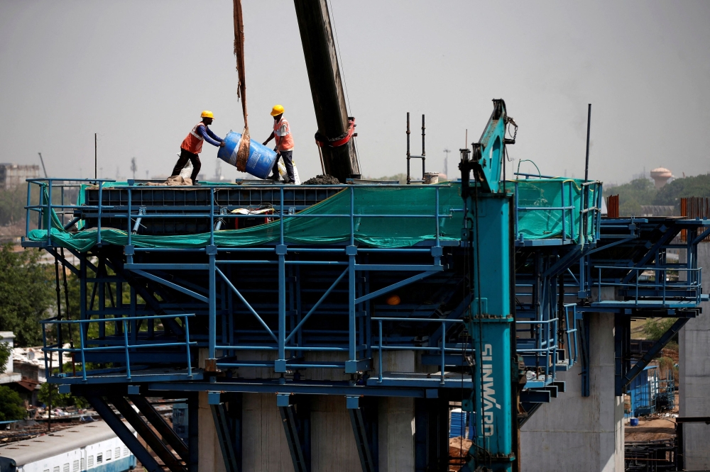 Labourers work at a construction site of the Ahmedabad-Mumbai High Speed Rail corridor in Ahmedabad, India, May 31, 2023. — Reuters pic  