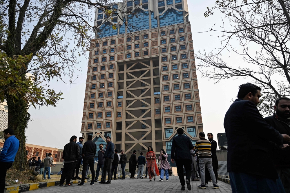 People gather outside a building in the aftermath of an earthquake in Islamabad on January 11, 2024. A powerful 6.4-magnitude earthquake hit north-eastern Afghanistan today, shaking buildings from the capital Kabul to Islamabad in neighbouring Pakistan. — AFP pic 