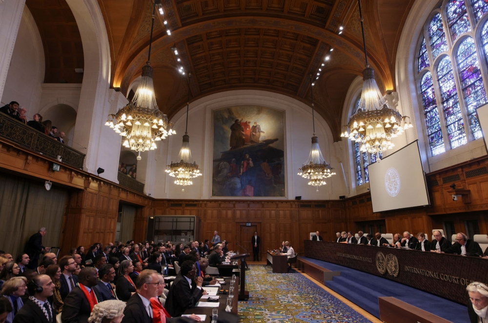 People sit inside the International Court of Justice (ICJ) on the day of the trial to hear a request for emergency measures by South Africa, who asked the court to order Israel to stop its military actions in Gaza and to desist from what South Africa says are genocidal acts committed against Palestinians during the war with Hamas in Gaza, in The Hague January 11, 2024. — Reuters pic  