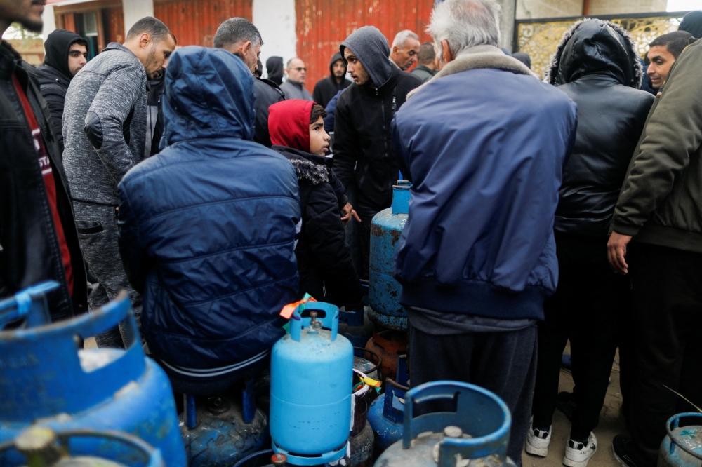 Palestinians wait to fill their cylinders with cooking gas amid shortage, as the conflict between Israel and Hamas continues, in Rafah, in the southern Gaza Strip, January 11, 2024. — Reuters pic  