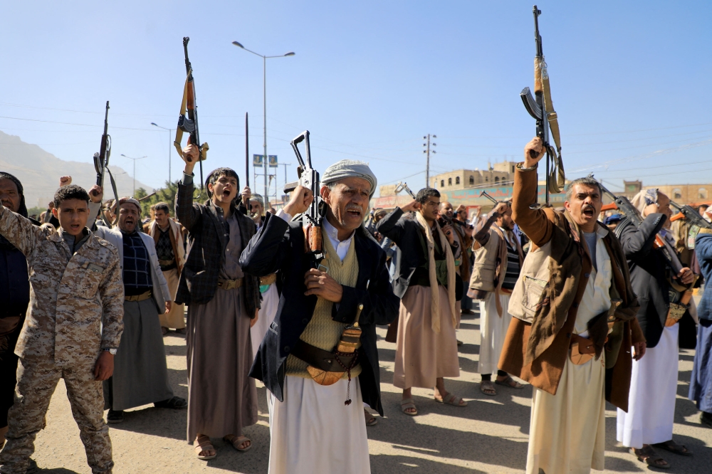 Demonstrators shout slogans and brandish their weapons during a march in solidarity with the Palestinian people, in the Huthi-controlled capital Sanaa on January 11, 2024, amid the ongoing battles between Israel and the militant Hamas group in Gaza. — AFP pic