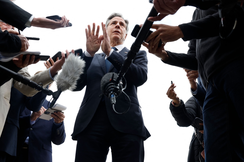 US Secretary of State Antony Blinken speaks to members of the media before boarding the plane in Cairo on January 11, 2024 on his way  back to Washington DC. — AFP pic