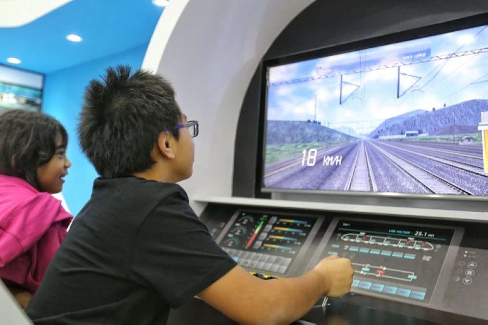 A child plays the role of a train captain in KL-Singapore HSR project exhibition at NU Sentral, Kuala Lumpur, June 15, 2016. ― File picture by Saw Siow Feng