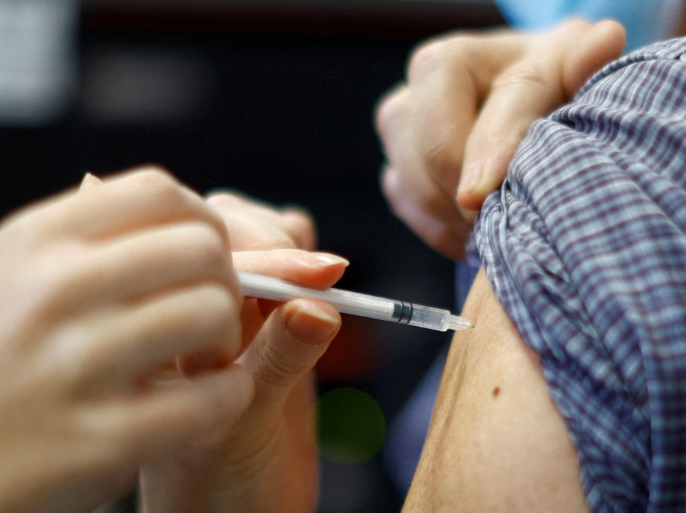 Low vaccination rates against the latest versions of Covid-19 and influenza are putting pressure on healthcare systems this winter, leading public health officials told Reuters. — Reuters pic