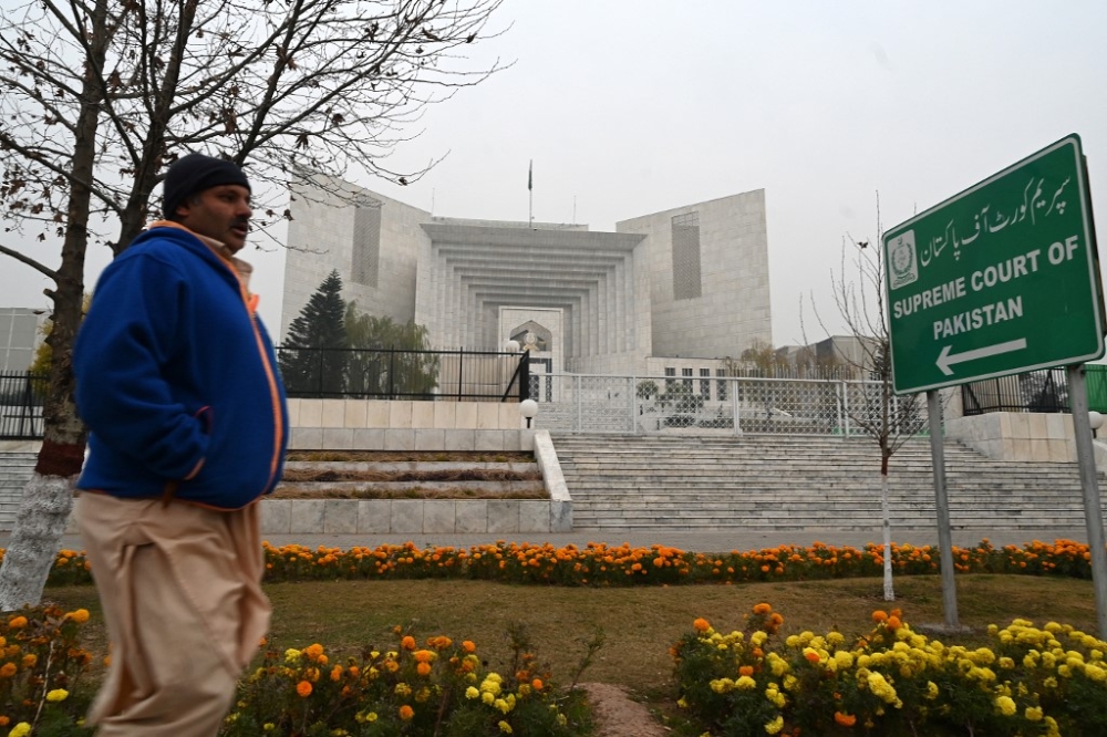 A man walks past the Pakistan’s Supreme Court building in Islamabad on January 12, 2024. A second judge’s resignation from Pakistan’s Supreme Court was accepted on January 12, amid concerns of a growing rift in the judiciary ahead of general elections next month. — AFP pic