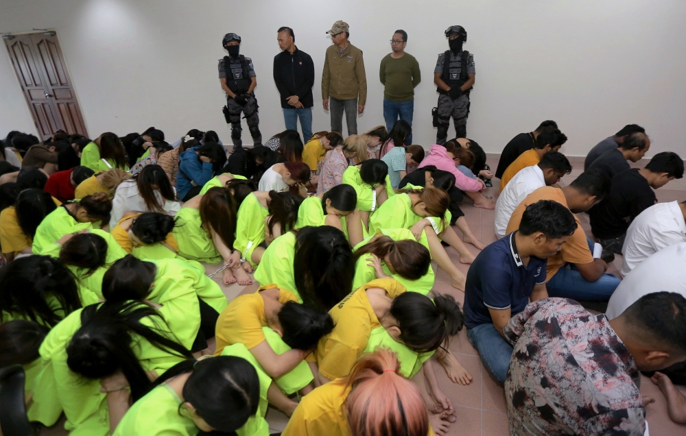 Immigration Department deputy-director general (Operations) Jafri Embok Taha (centre) said in raids at five separate locations involving two prostitution premises and three KTV entertainment centres here, 131 foreigners and 10 local citizens believed to be caretakers of the premises were detained. — Bernama pic