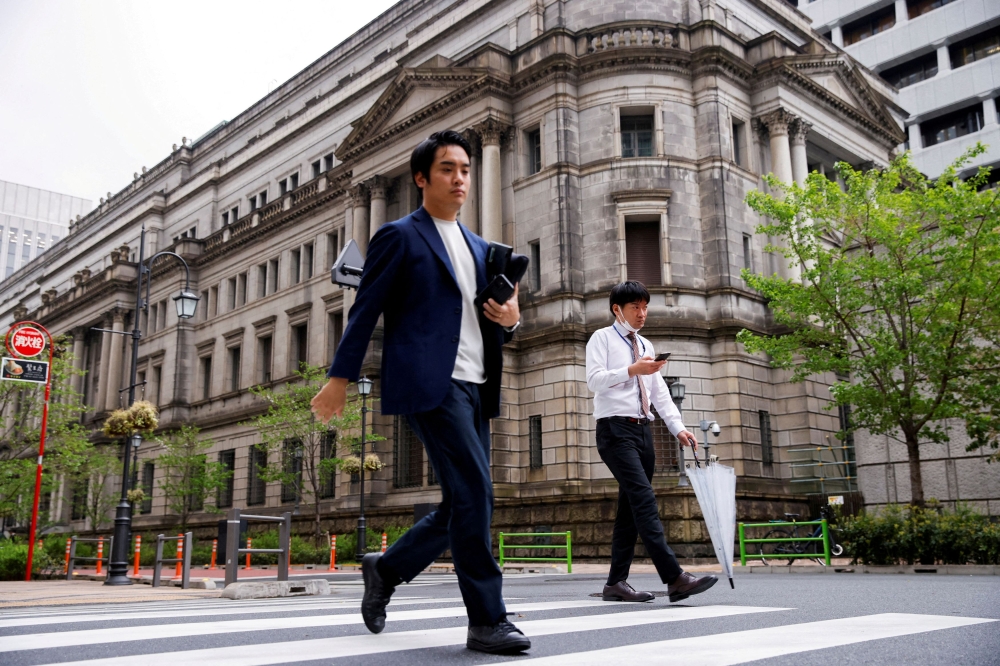 File photo of people walking in front of the bank of Japan building in Tokyo, Japan, April 7, 2023. — Reuters pic